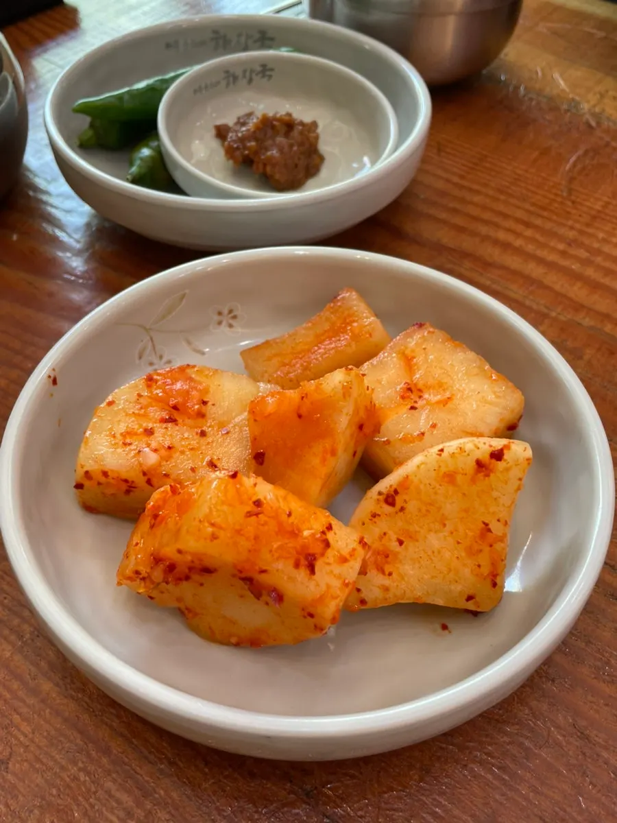 Side dishes of chili peppers and diced radish kimchi