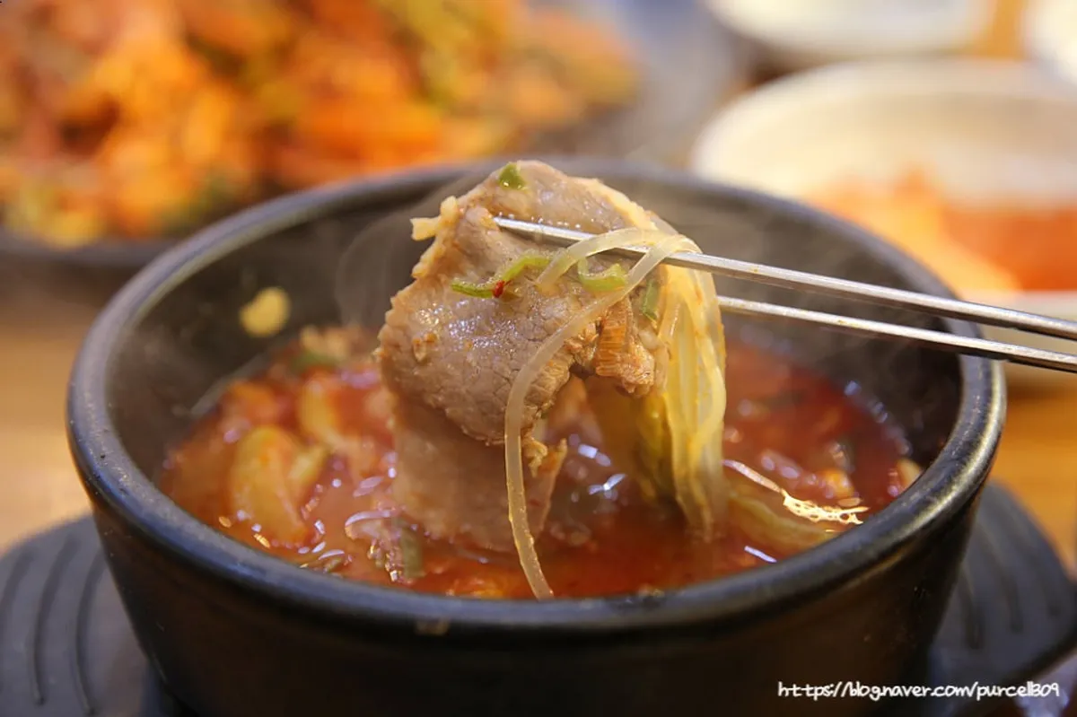 A spoonful of haejangguk with visible meat