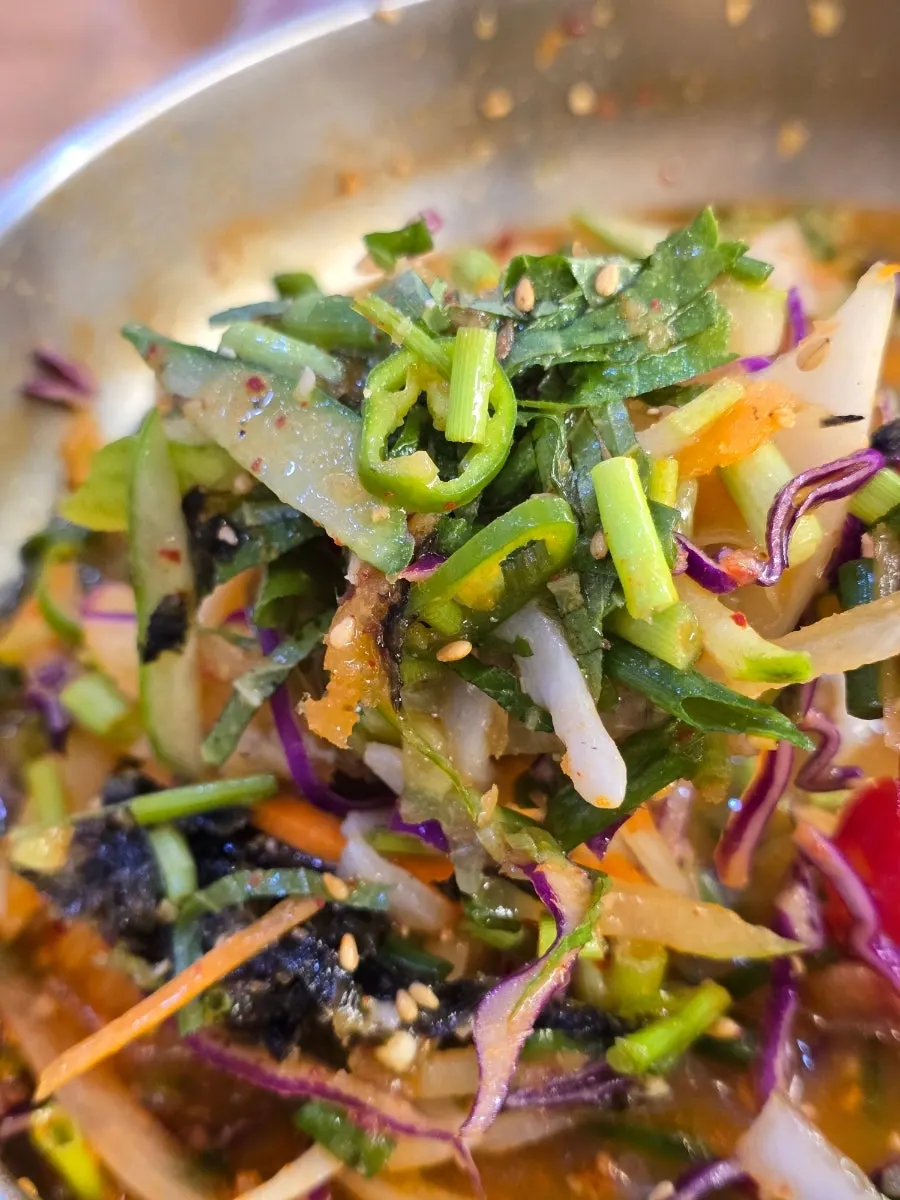 A bowl of hantchi mulhoe packed with vegetables