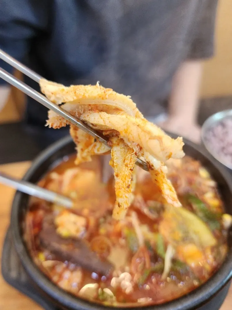 Close-up of tripe soup broth and ingredients