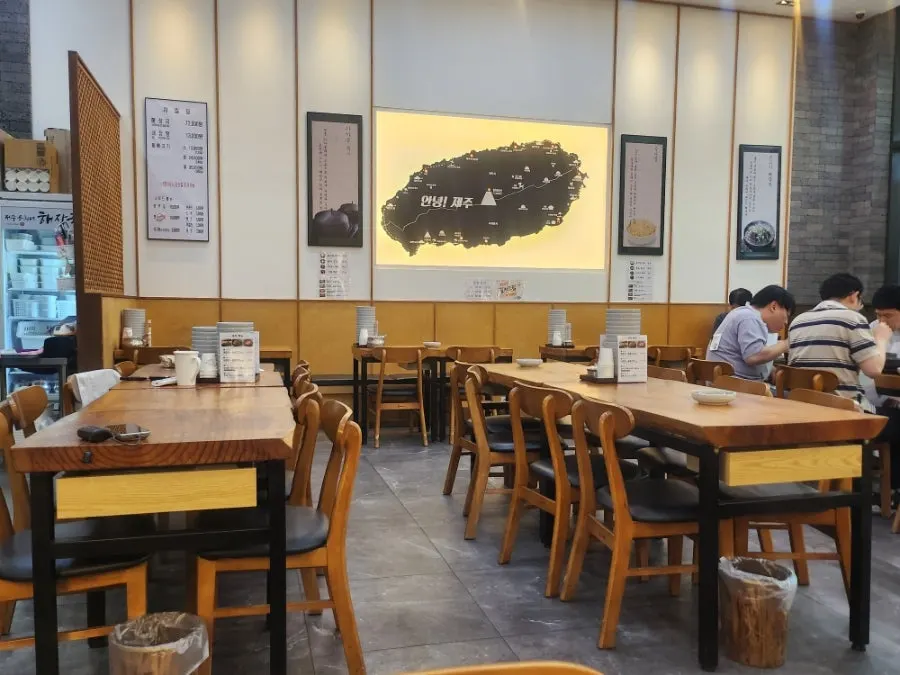 Restaurant interior with a long table and sofa seating