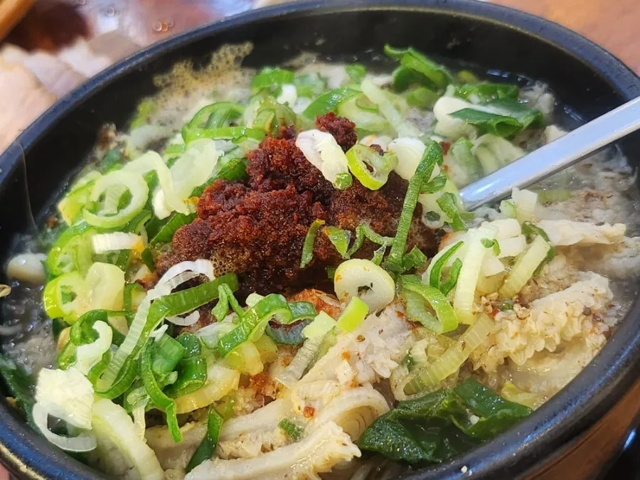 Whole clump of chili paste sitting atop the tripe soup