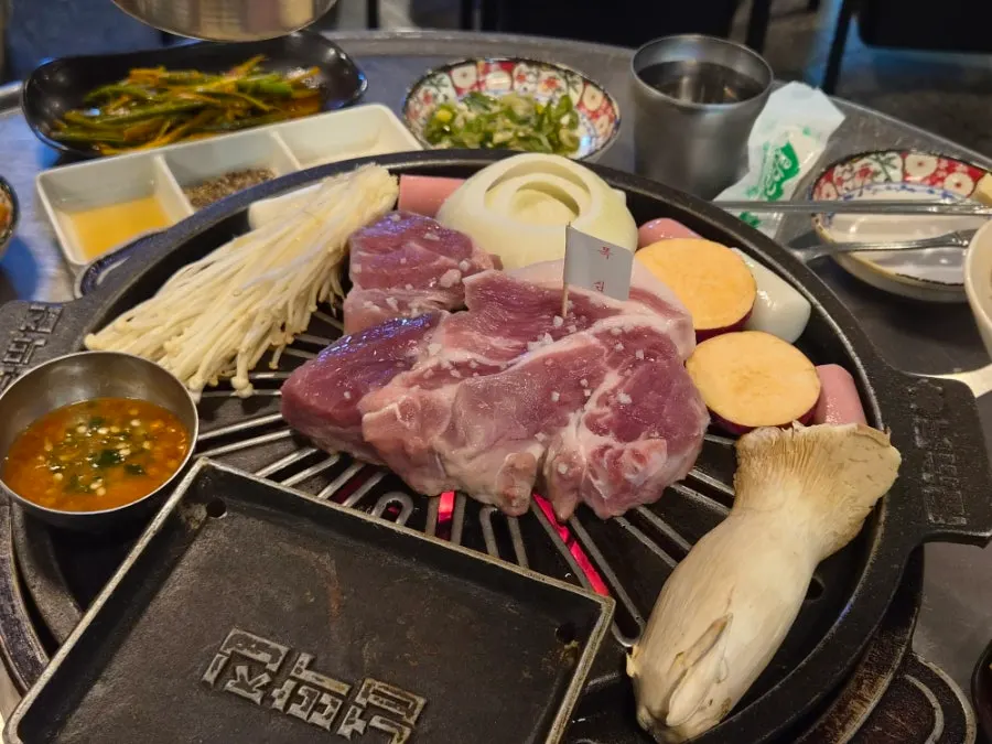 Pork neck and grilled vegetables on the cast-iron plate