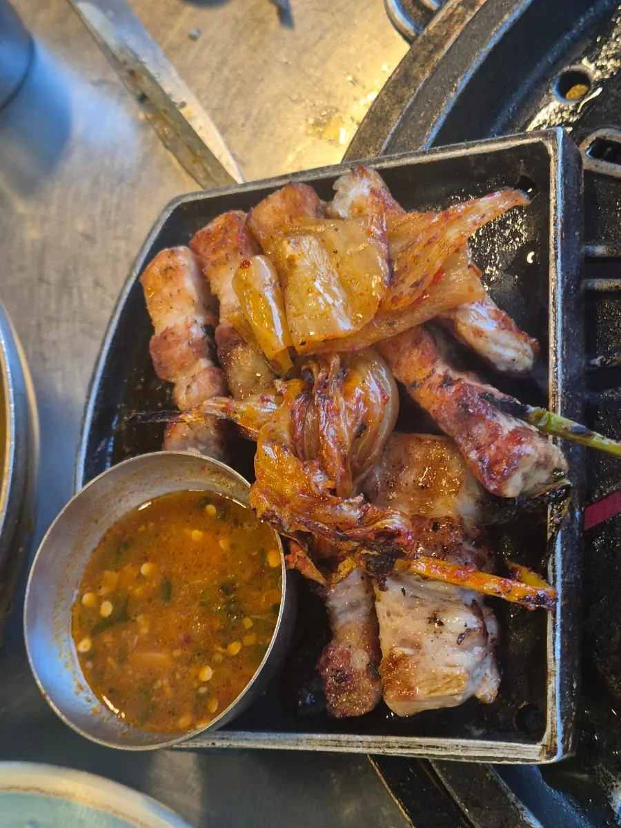 A golden-grilled, thick piece of pork belly