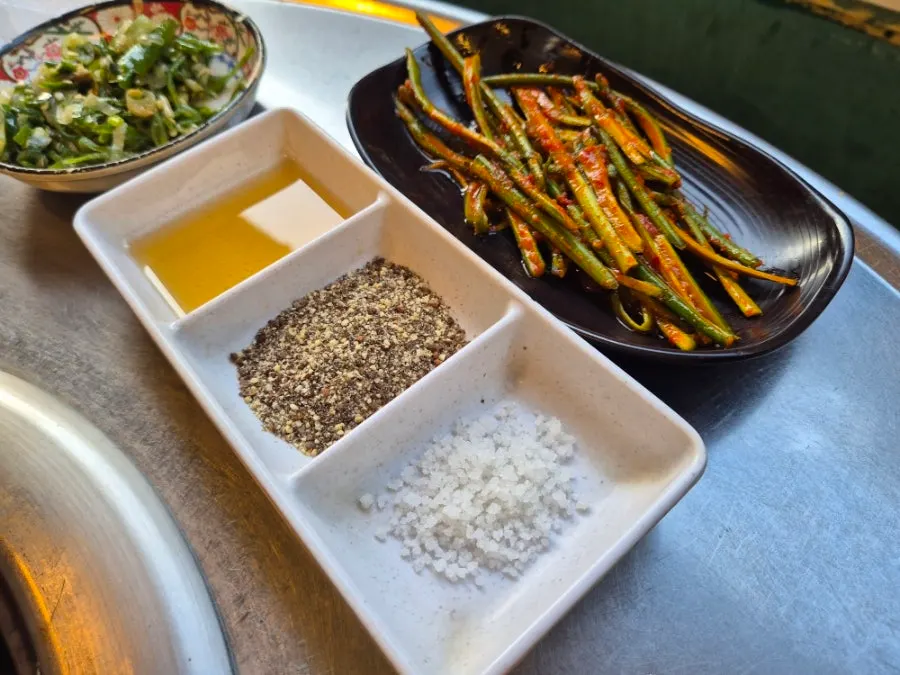 Table with pork belly and side dishes