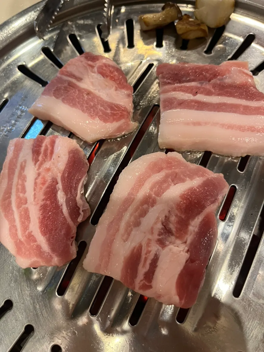 Two servings of Paldo pork belly with king oyster mushrooms