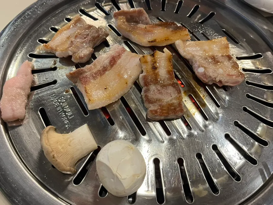 Pork belly cooking on the charcoal grill