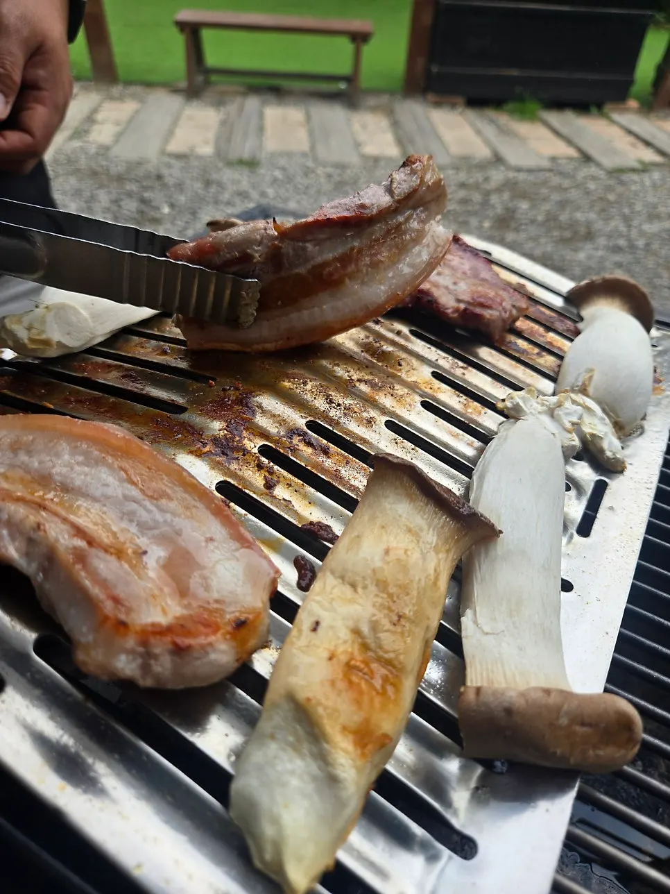 Pork sizzling on the charcoal grill