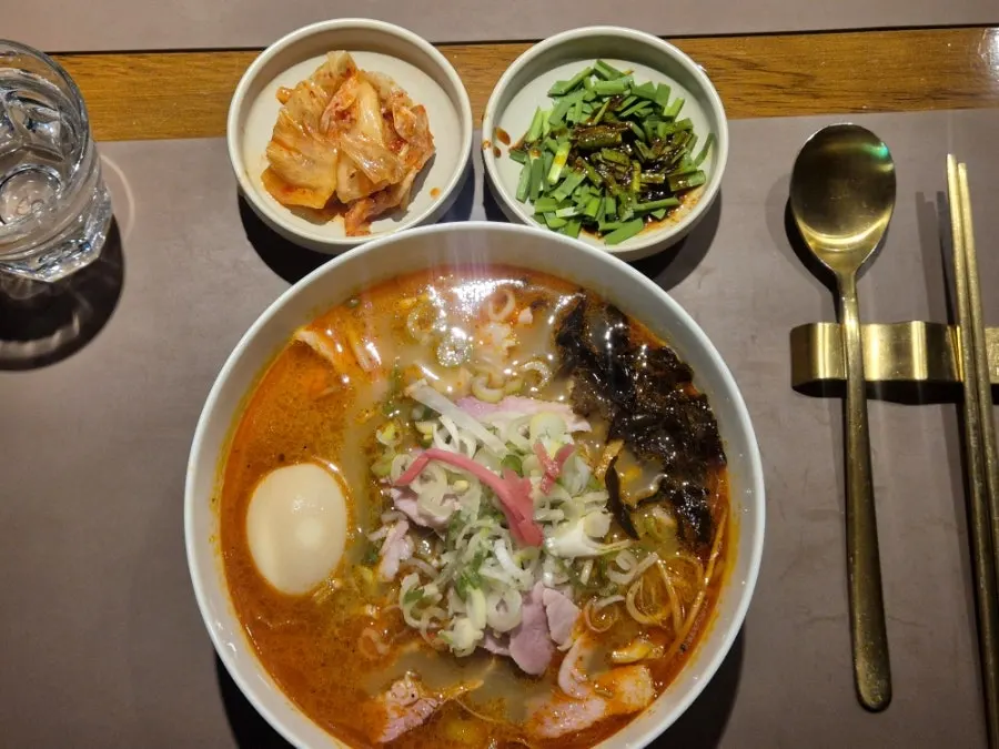 Table setting with bibim milmyeon and spicy pork gukbap together