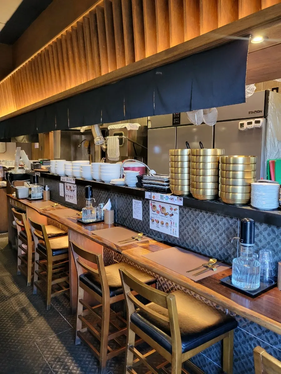Interior of Sanbandeul Pork Gukbap, styled like a ramen shop