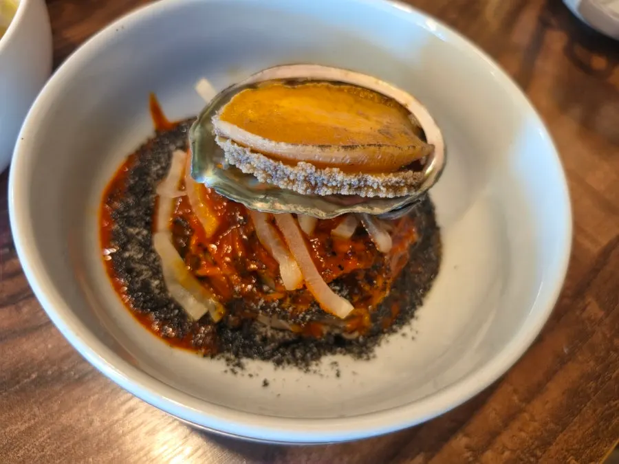 Abalone jang bibim naengmyeon topped with abalone