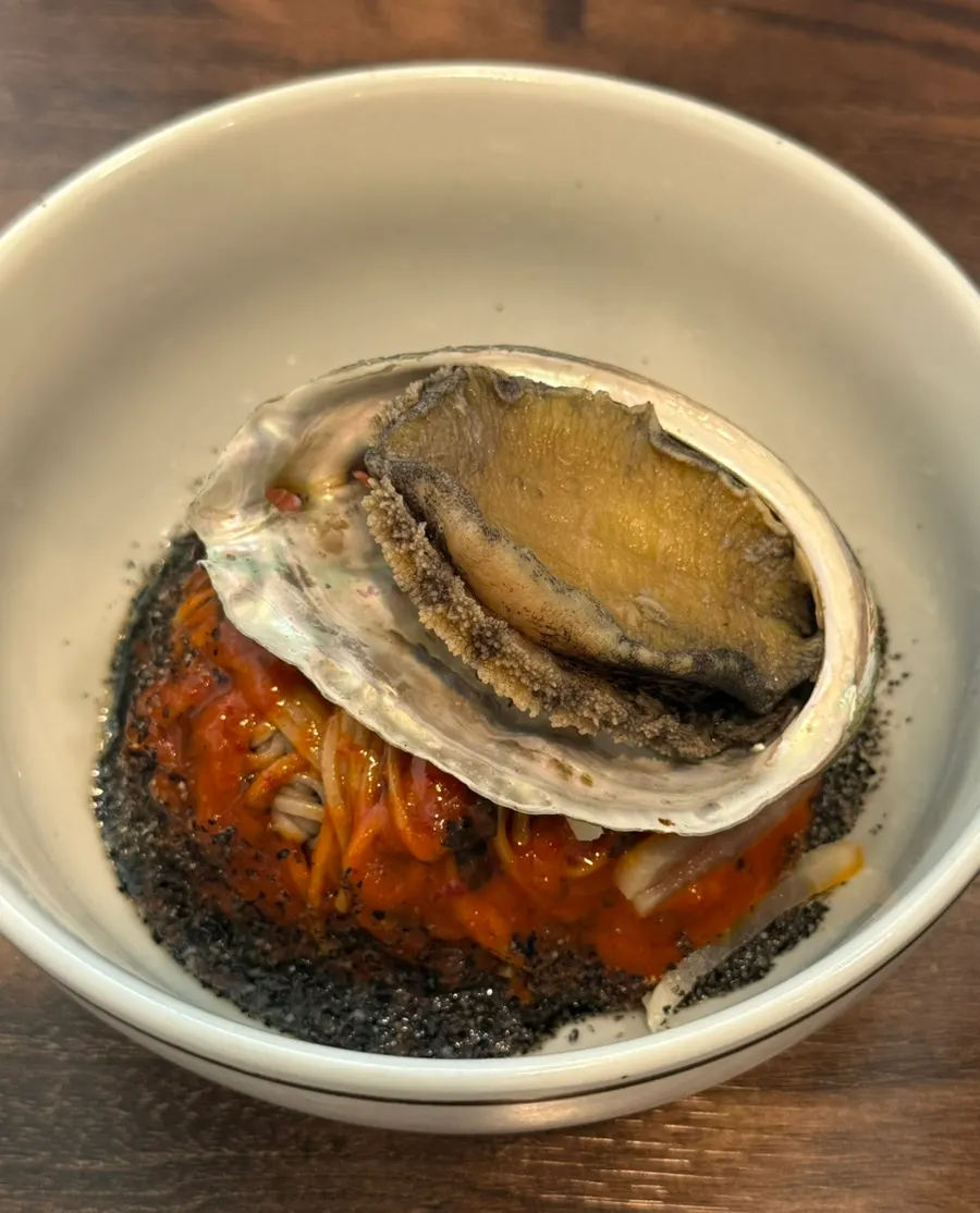 Abalone jang bibim naengmyeon topped with large abalone