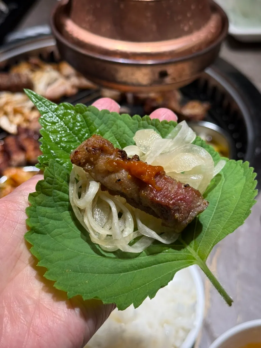 A well-cooked piece of pork belly dipped in salt