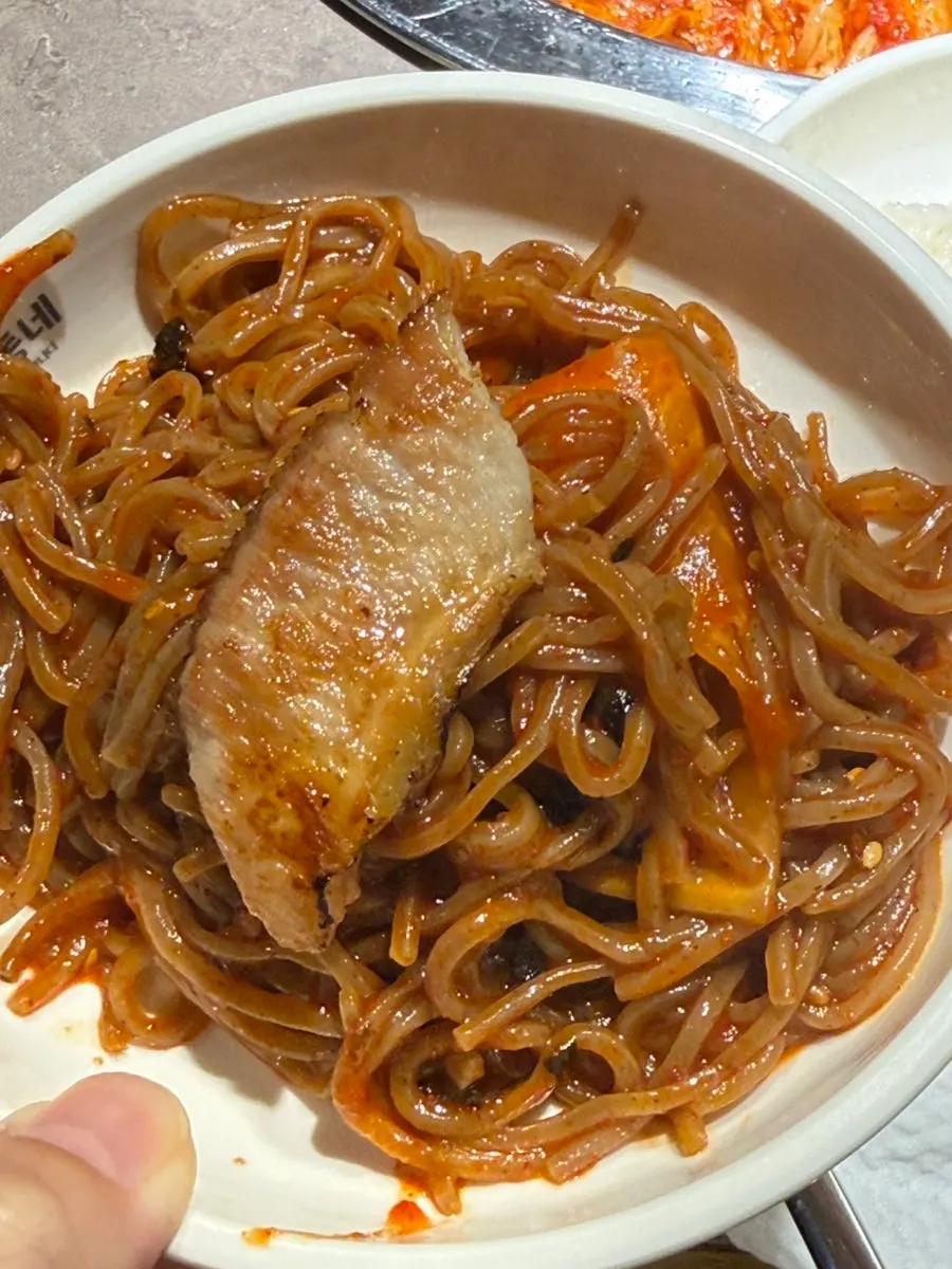 Bibim mak-guksu paired with a piece of grilled meat