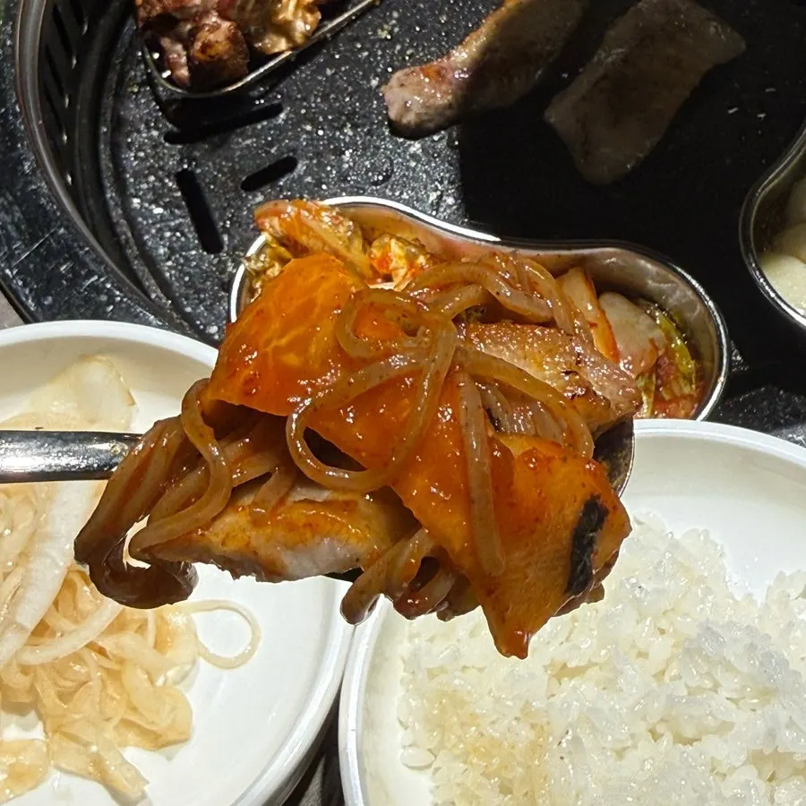Table setting with cauldron rice, doenjang stew, and meat