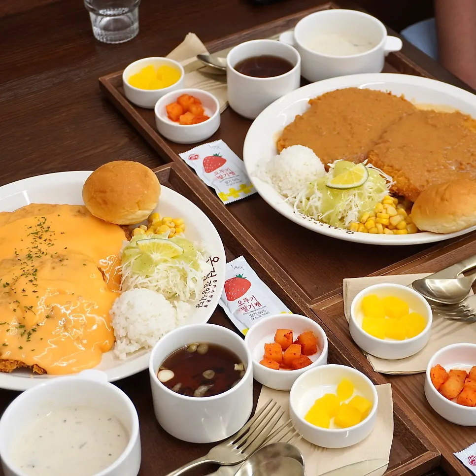A plate of pork cutlet drizzled with sauce