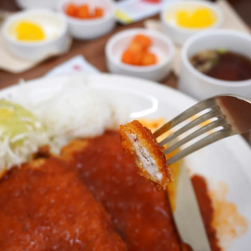Picking up a piece of the classic gyeongyangsik pork cutlet
