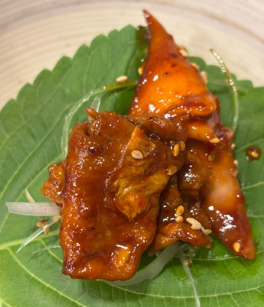 Oje Bokkeum topped with scallion strands and jjolmyeon noodles