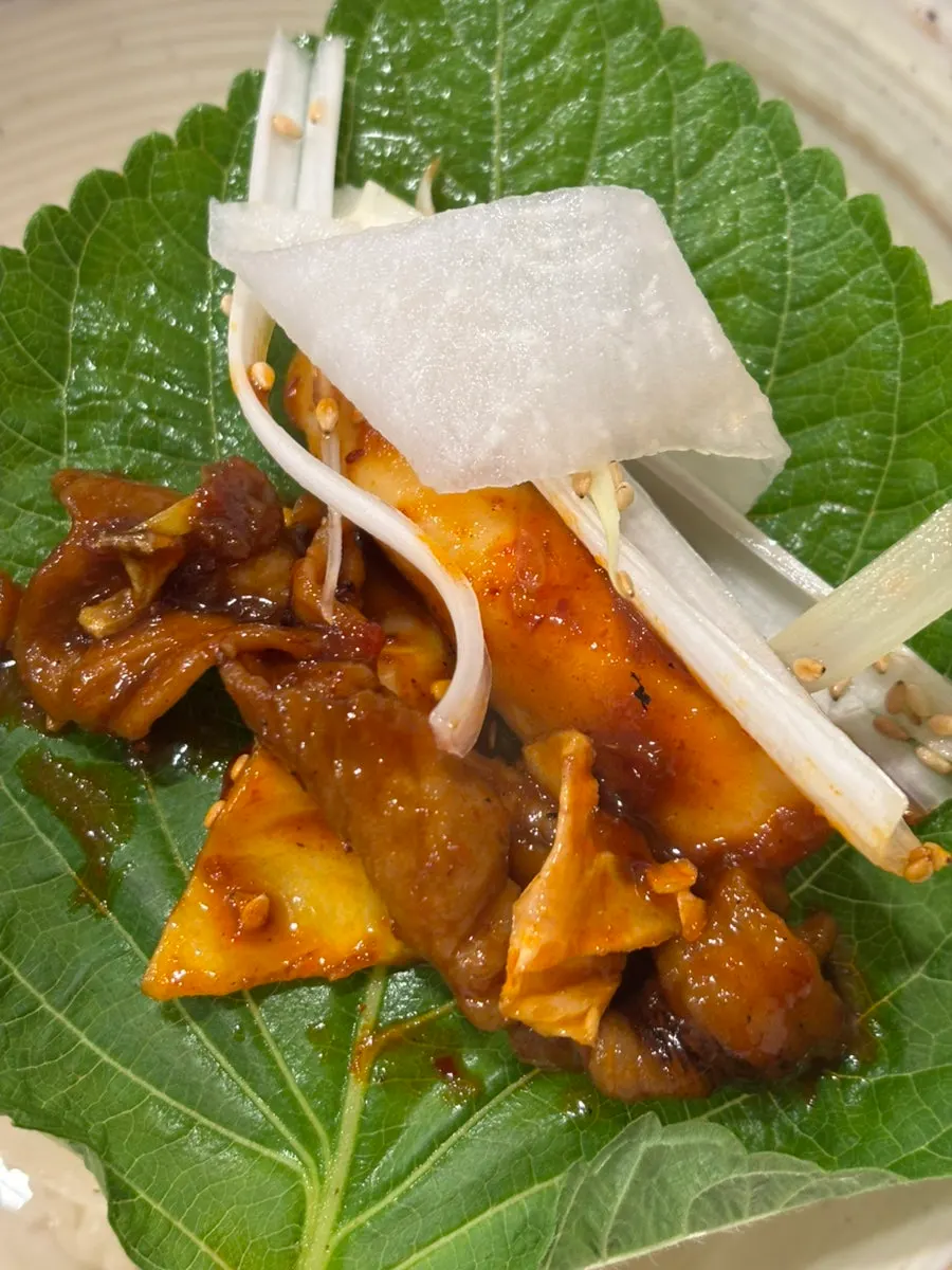 Oje Bokkeum wrap with bean sprouts and pickled radish