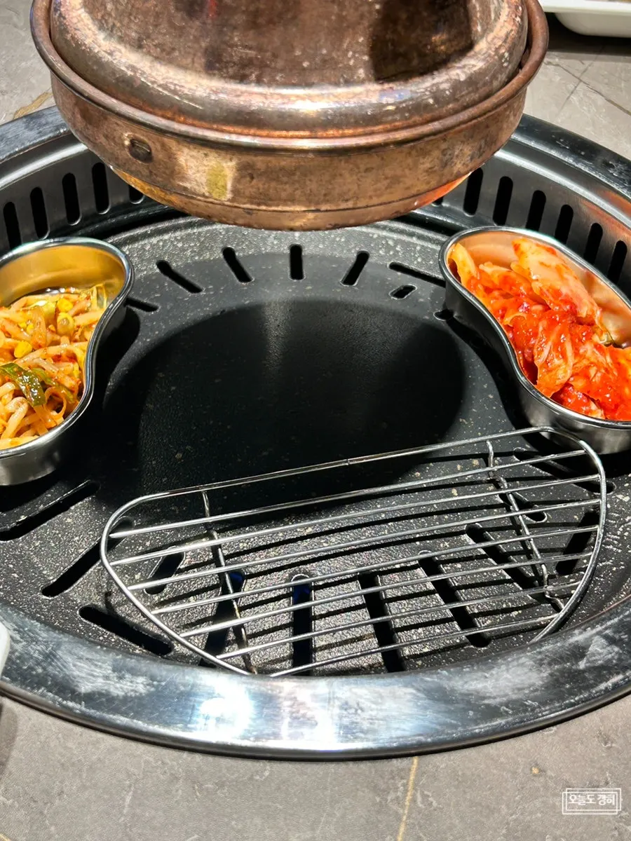 Pork belly, kimchi, and bean sprouts placed on the grill