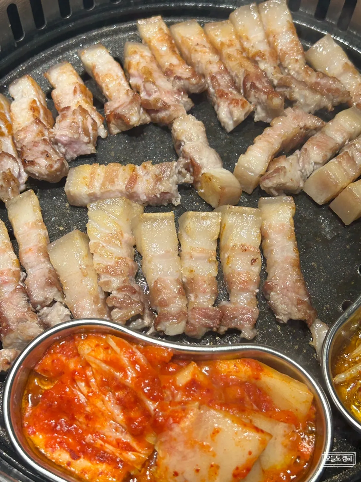 Pork belly cut with scissors cooking on the grill