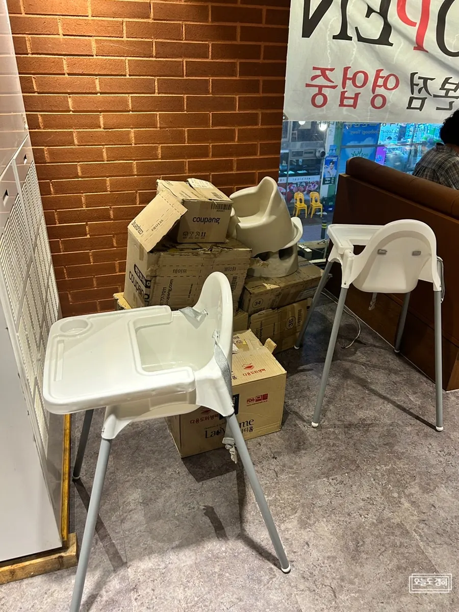 A corner of the restaurant set up with baby chairs and a booster seat
