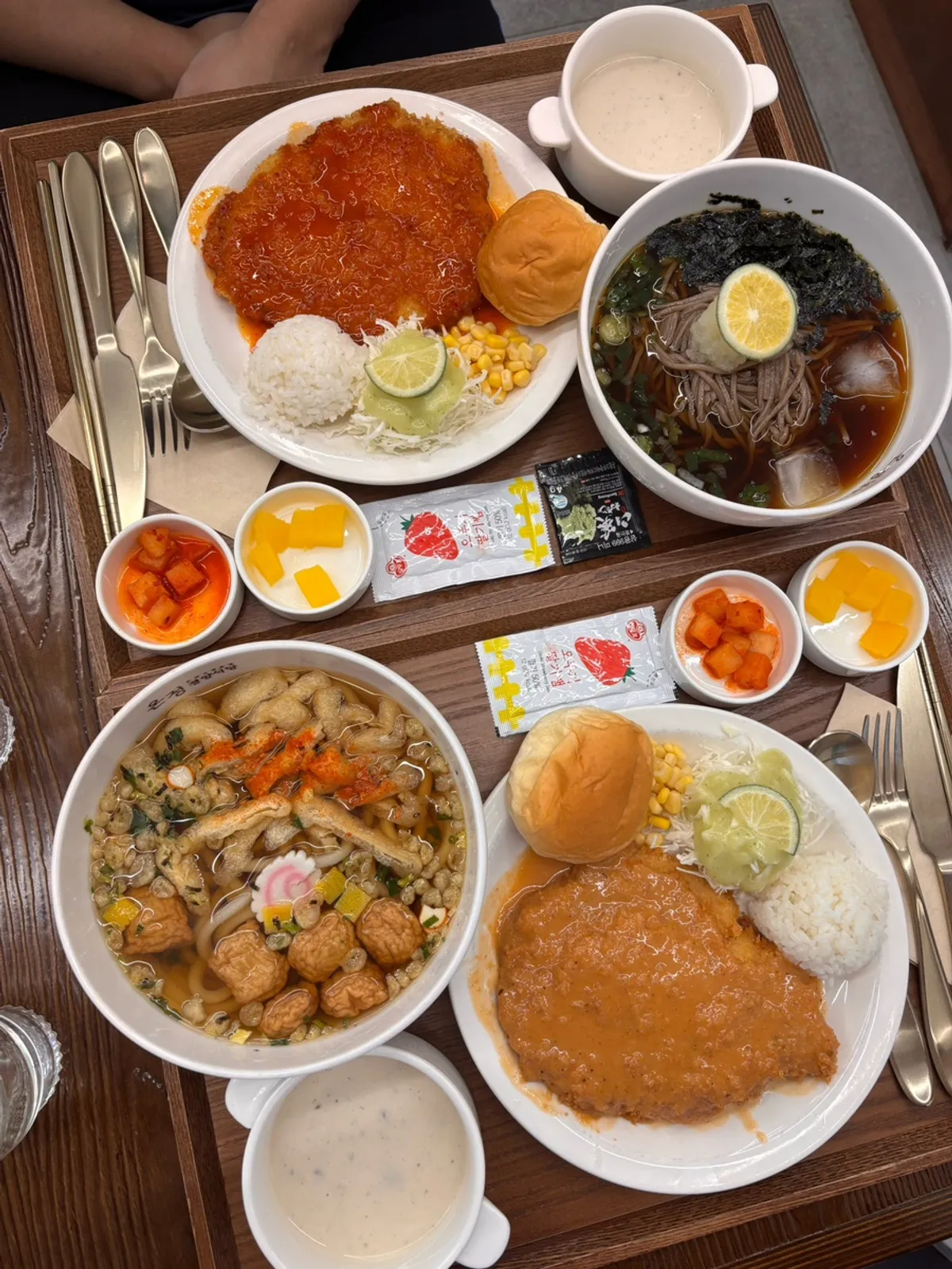 Gyeongyangsik pork cutlet set and spicy pork cutlet set laid out on the table