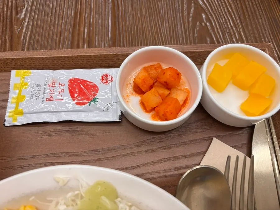 A piece of gyeongyangsik pork cutlet dipped in sauce