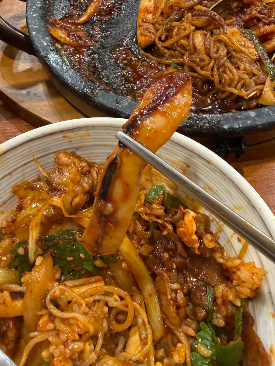 直火の香りが漂う石板炒め物のクローズアップ