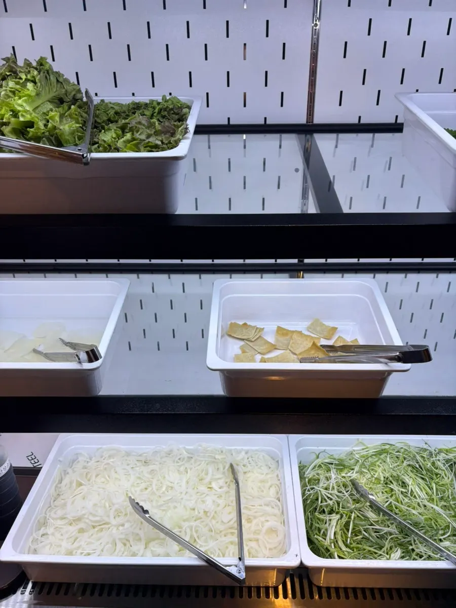 Lettuce and wrapping vegetables at the self-serve bar