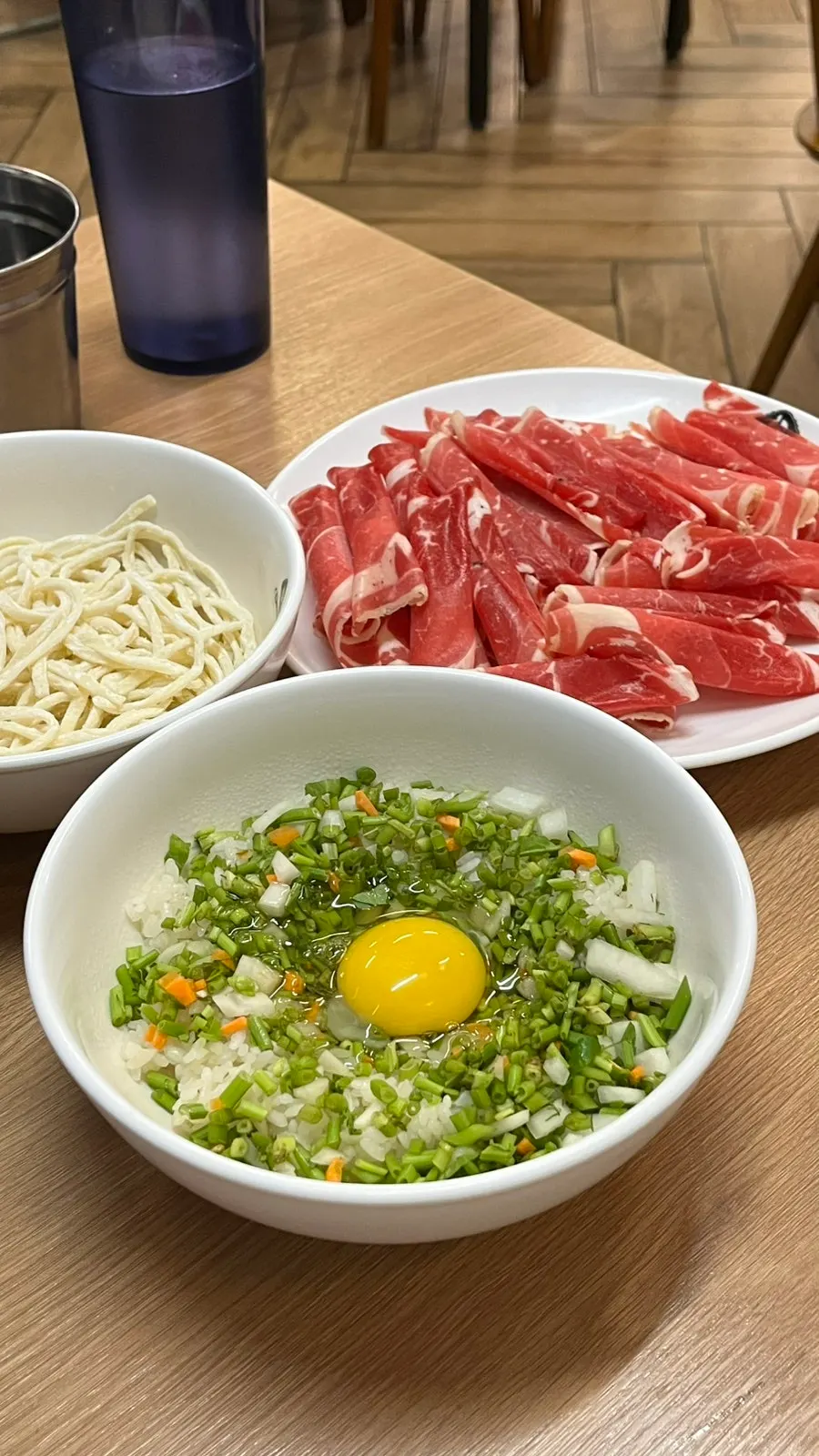 Table set with beef, kalguksu noodles, and fried rice ingredients