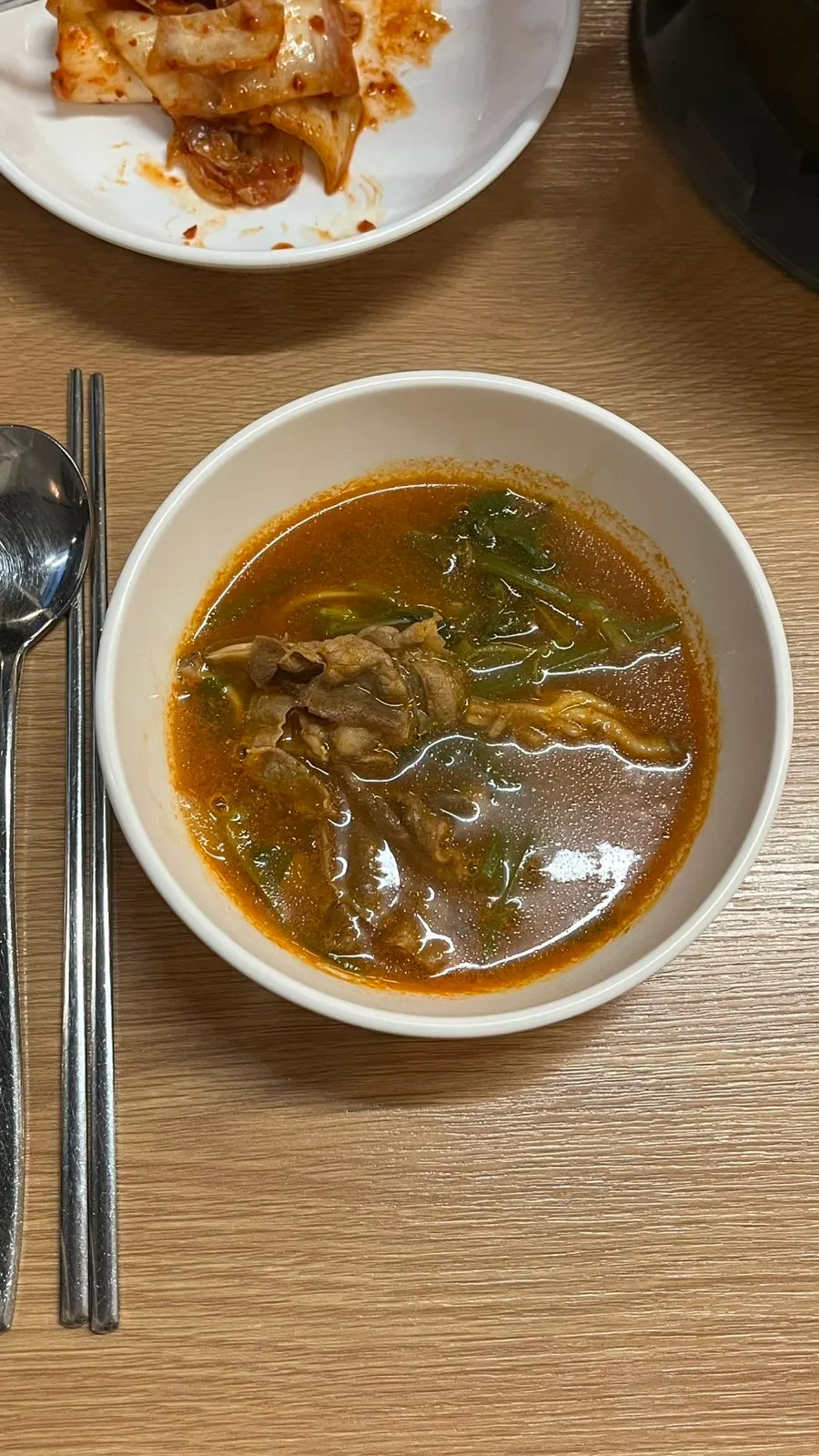 Pot of spicy mushroom shabu-shabu kalguksu starting to boil