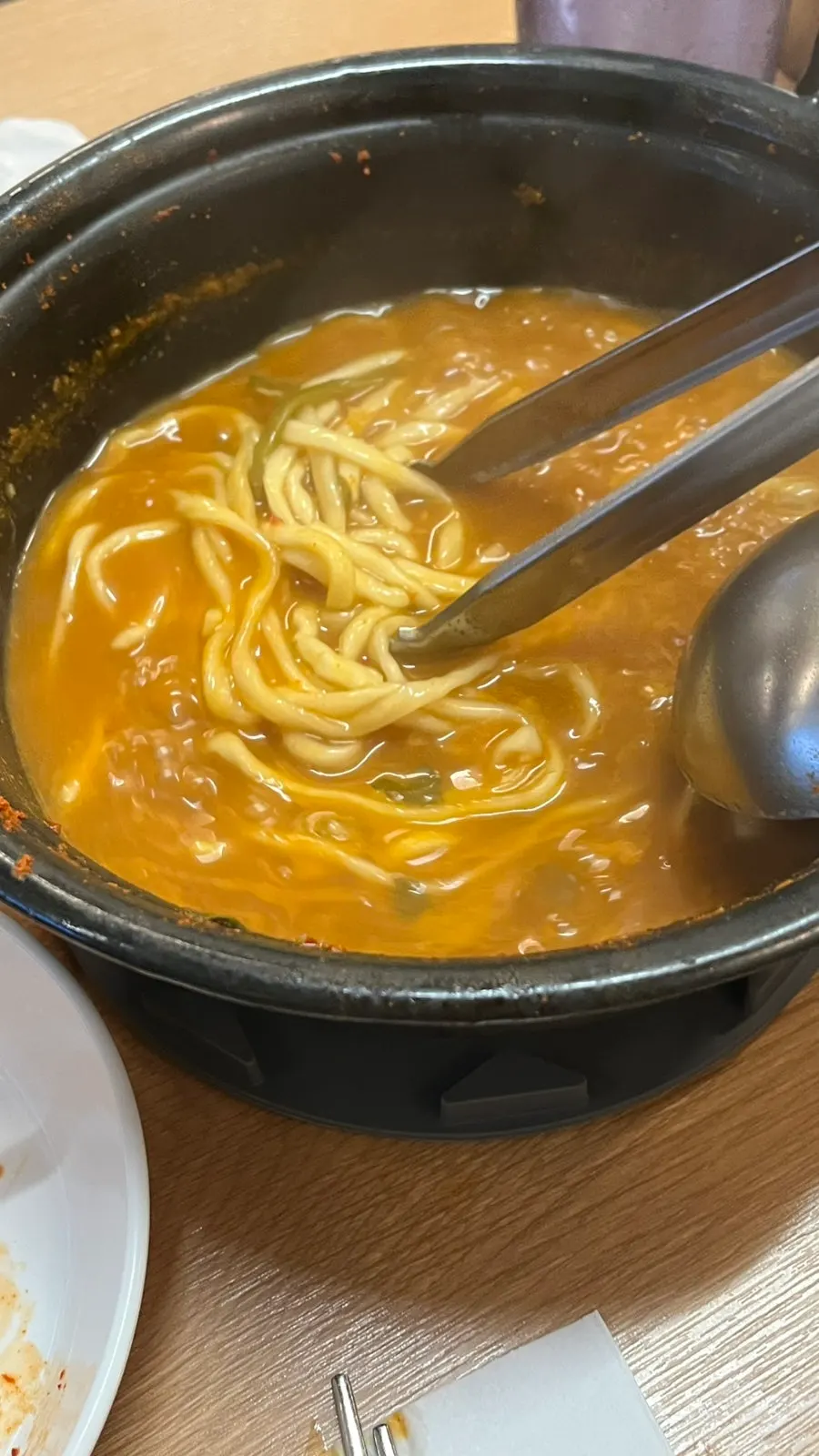 The spicy broth remaining in the pot after the shabu ingredients are eaten