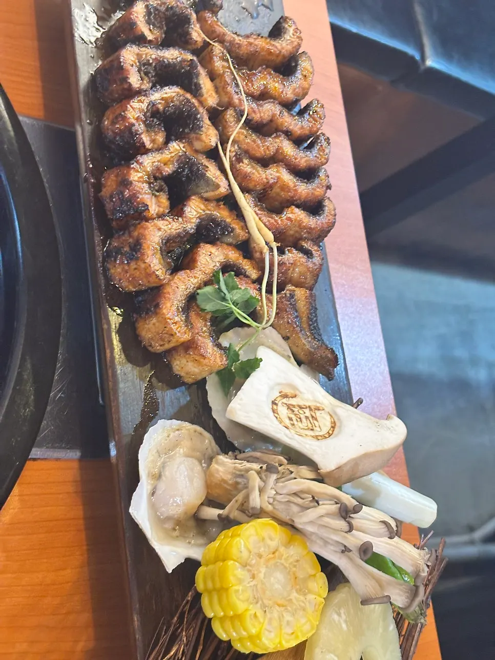 Grilled eel plate topped with sesame seeds and perilla leaves