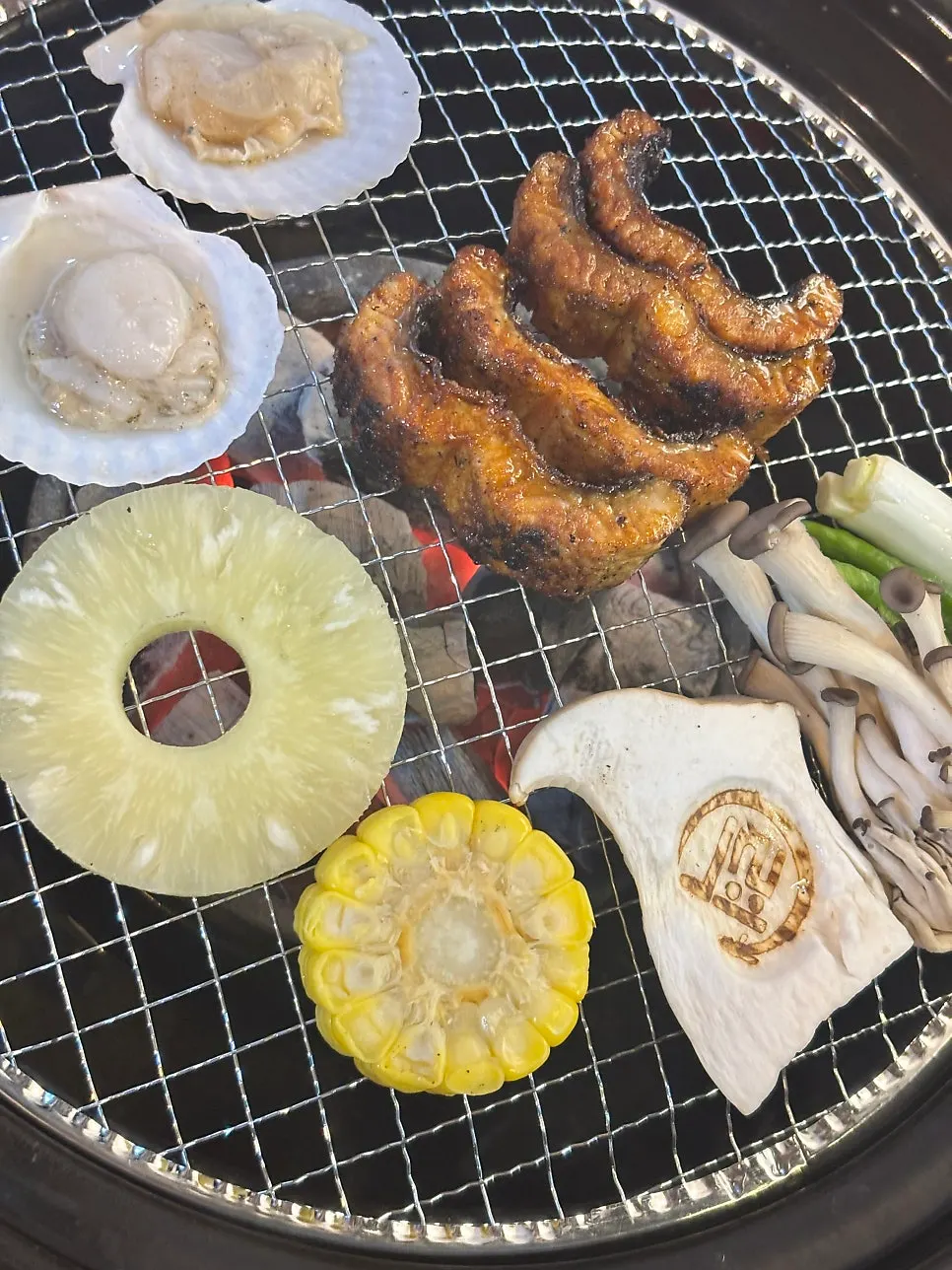 Pre-grilled eel being warmed carefully without burning