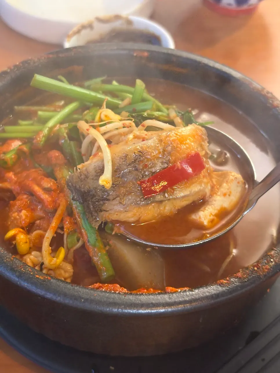 Inside the spicy fish stew with two chunks of fish