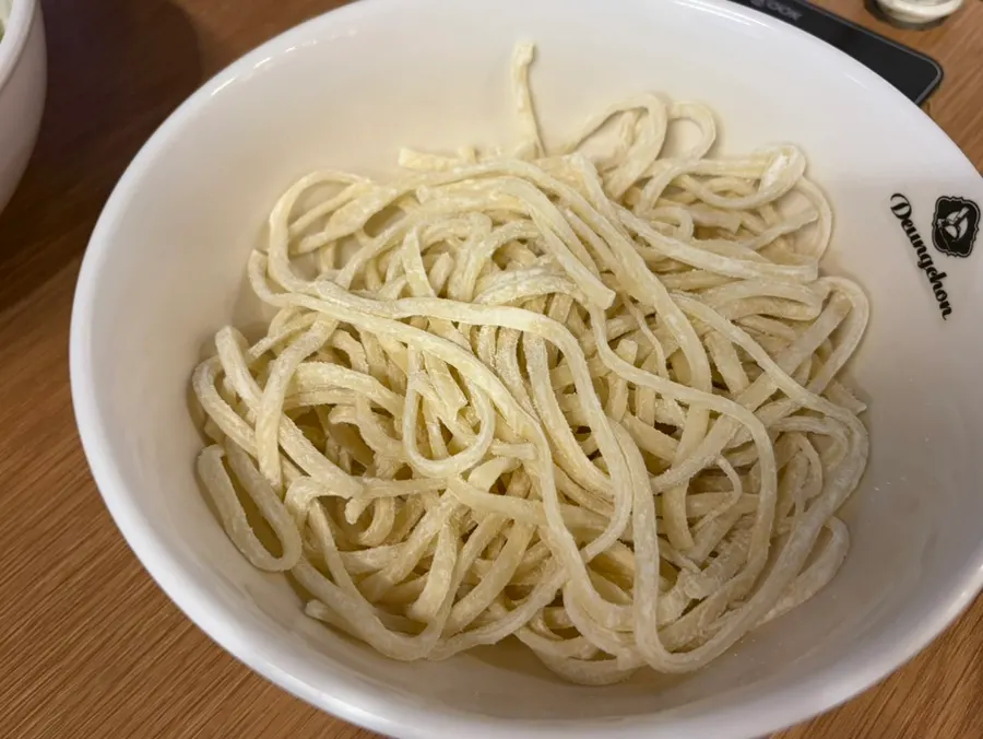 Kalguksu noodles cooked in the spicy broth