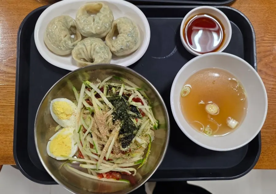 Bibim guksu dumpling set topped with cucumber