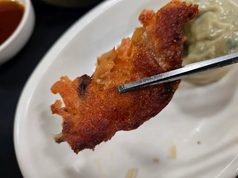 A piece of kimchijeon next to the kongguksu
