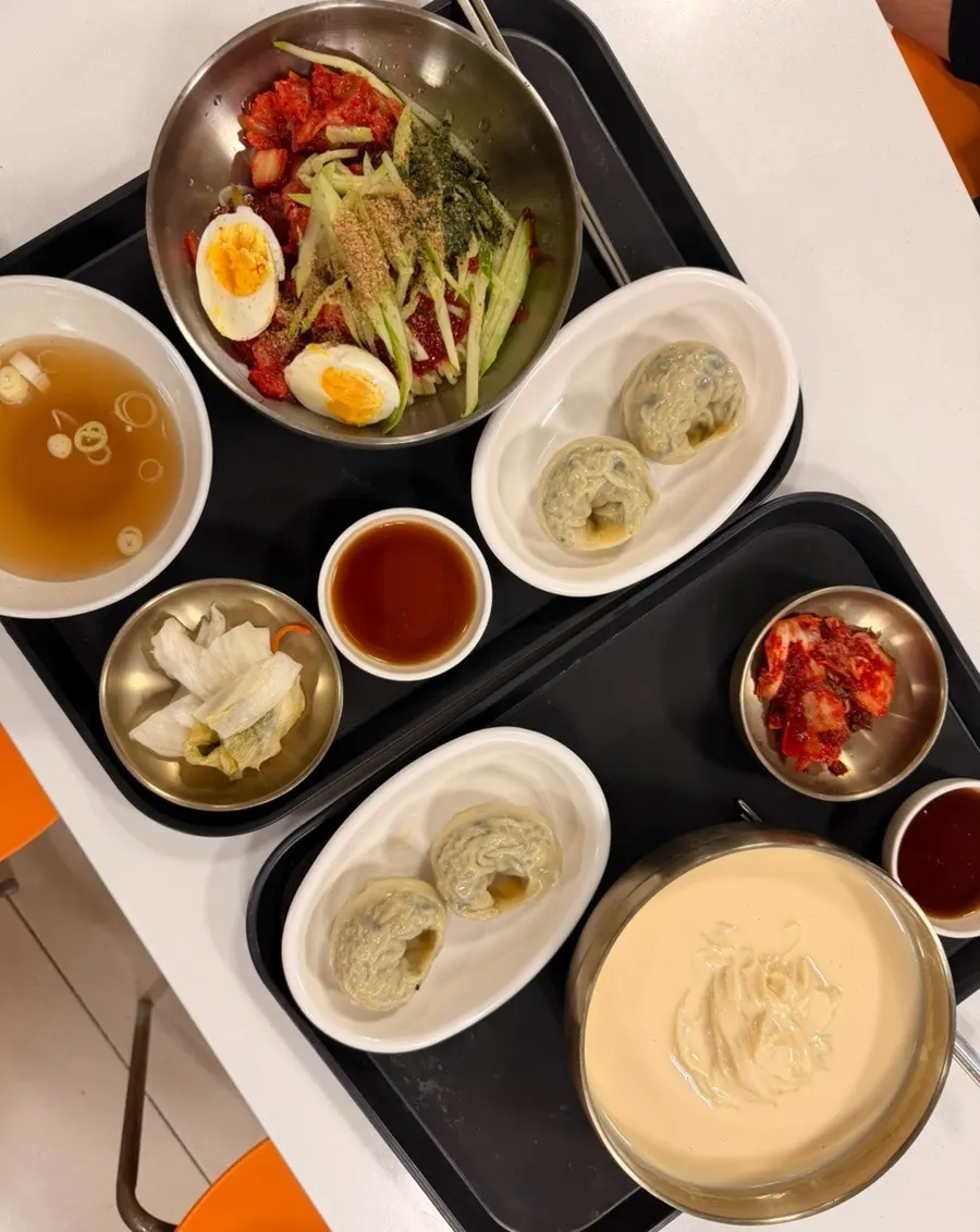 Kongguksu set and kimchi bibim guksu set served on trays