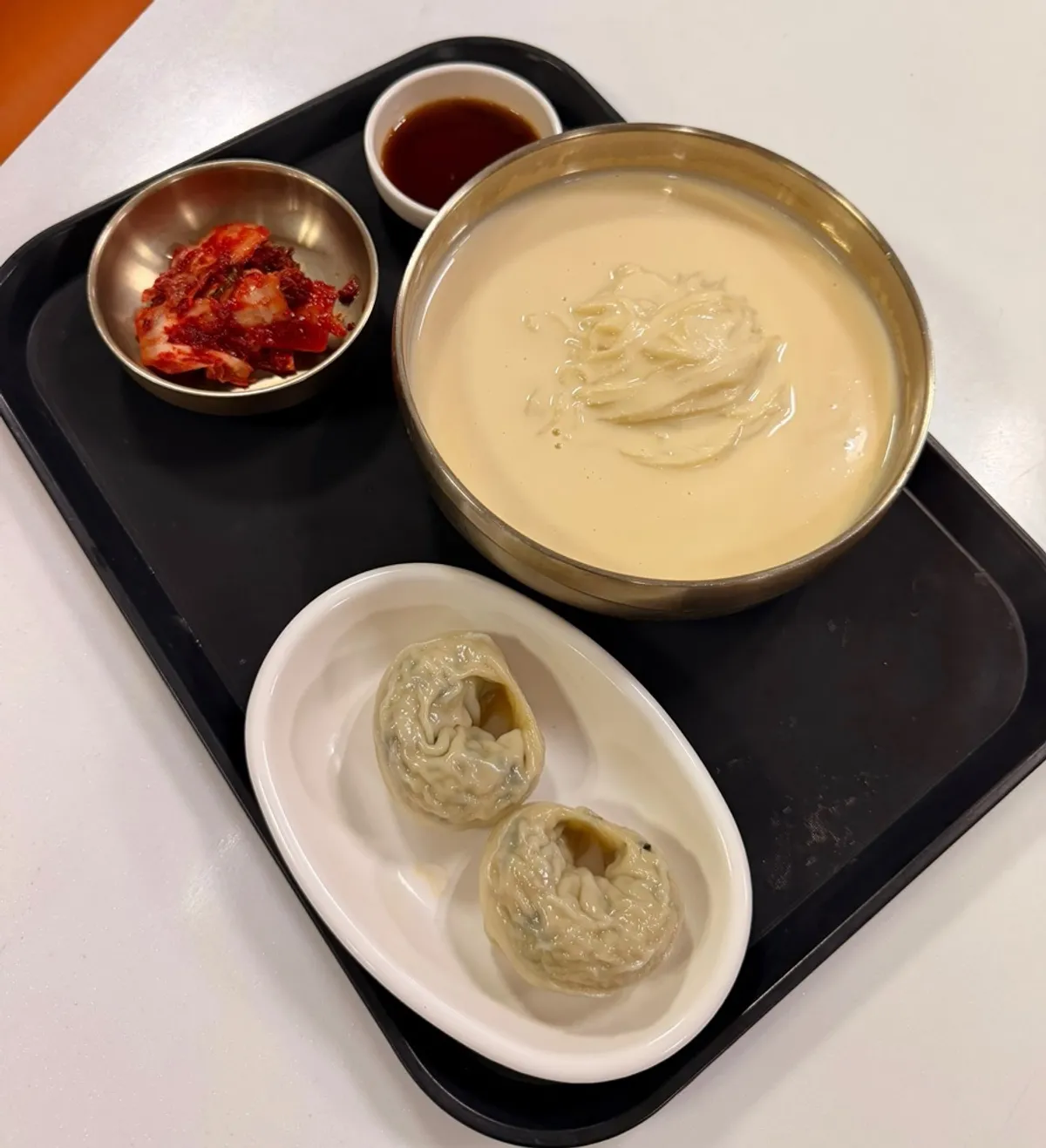 Sangam Hoegwan's kongguksu served in brass-toned bowl