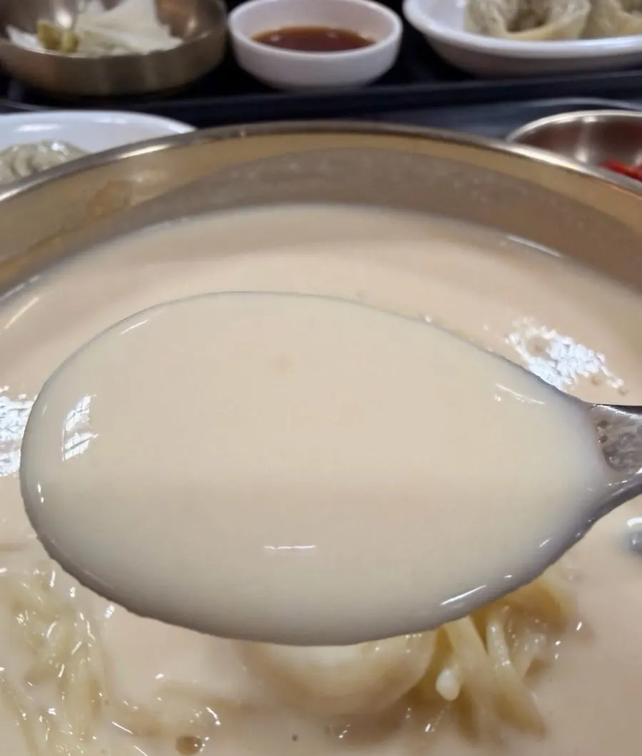 Close-up of the thick, creamy soy milk broth in the kongguksu