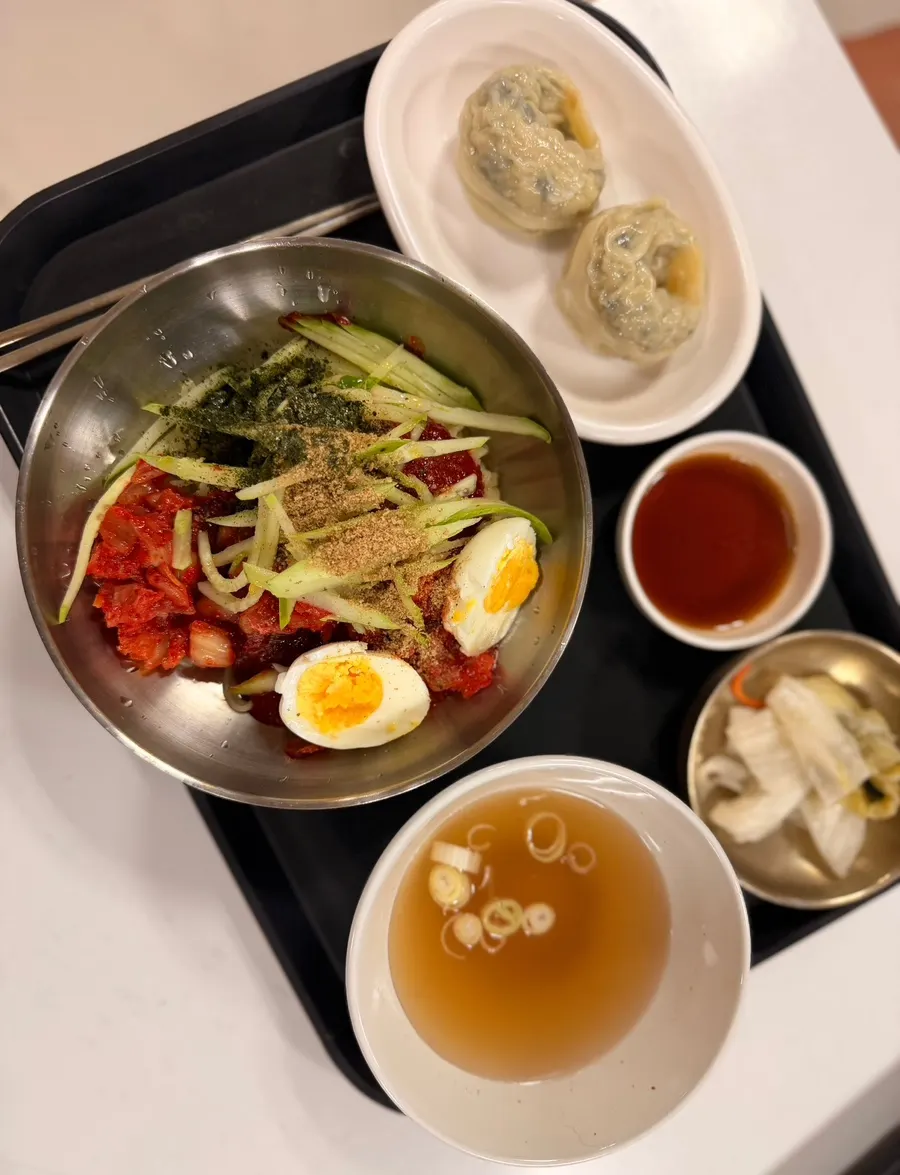 Kimchi bibim guksu topped with cucumber, gim flakes and boiled egg