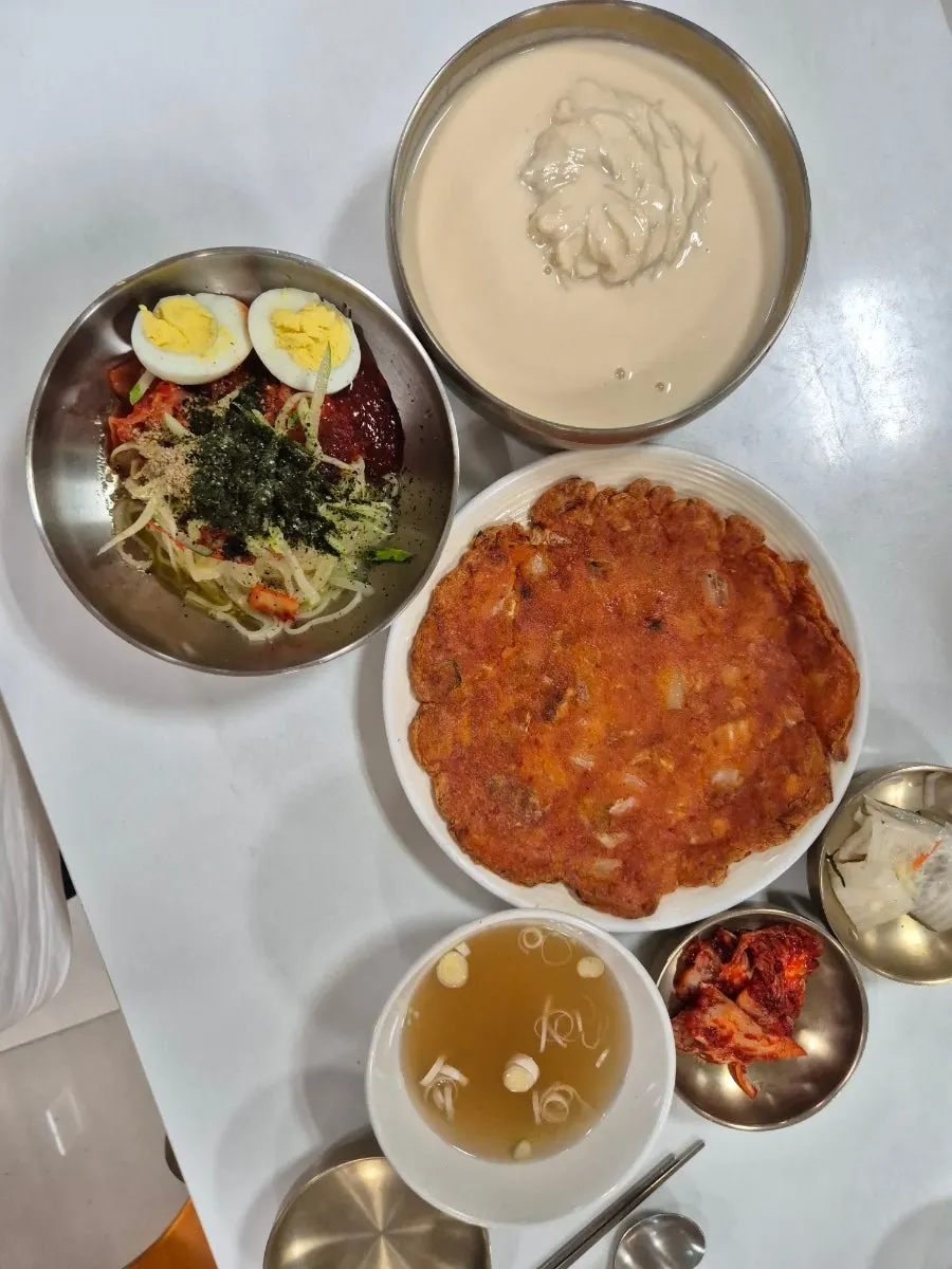 A spread of kongguksu, bibim guksu, and kimchi pancake