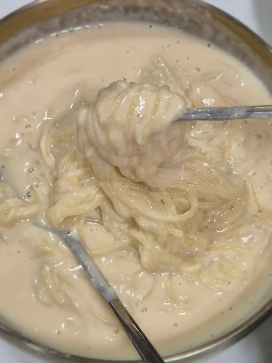 Kongguksu noodles lifted with chopsticks