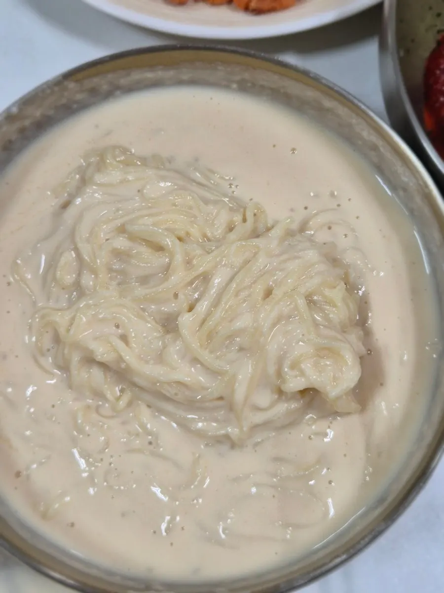 Close-up of kongguksu filled with soy broth