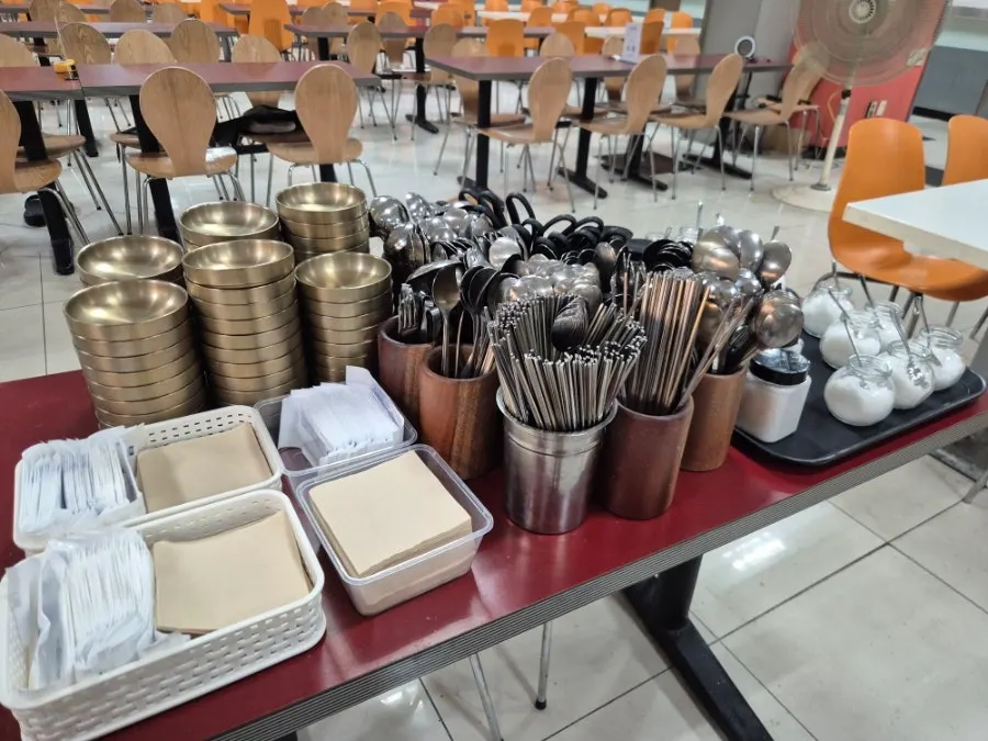 Tableware neatly arranged at the self-serve corner