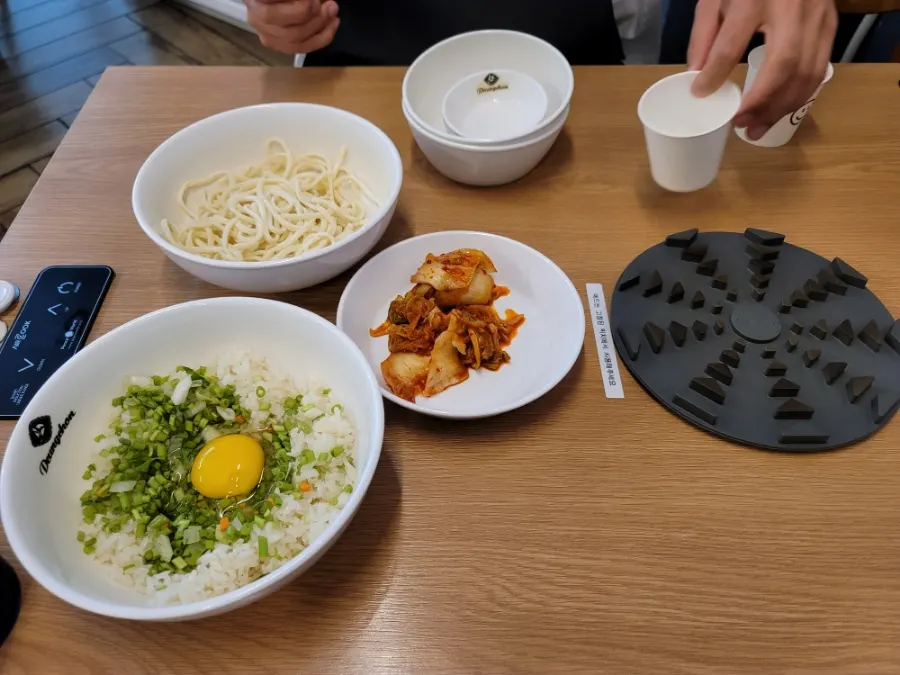 Kalguksu noodles, fried rice, and kimchi served first
