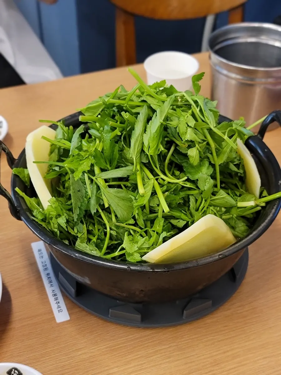 Generous amount of minari added to the spicy broth