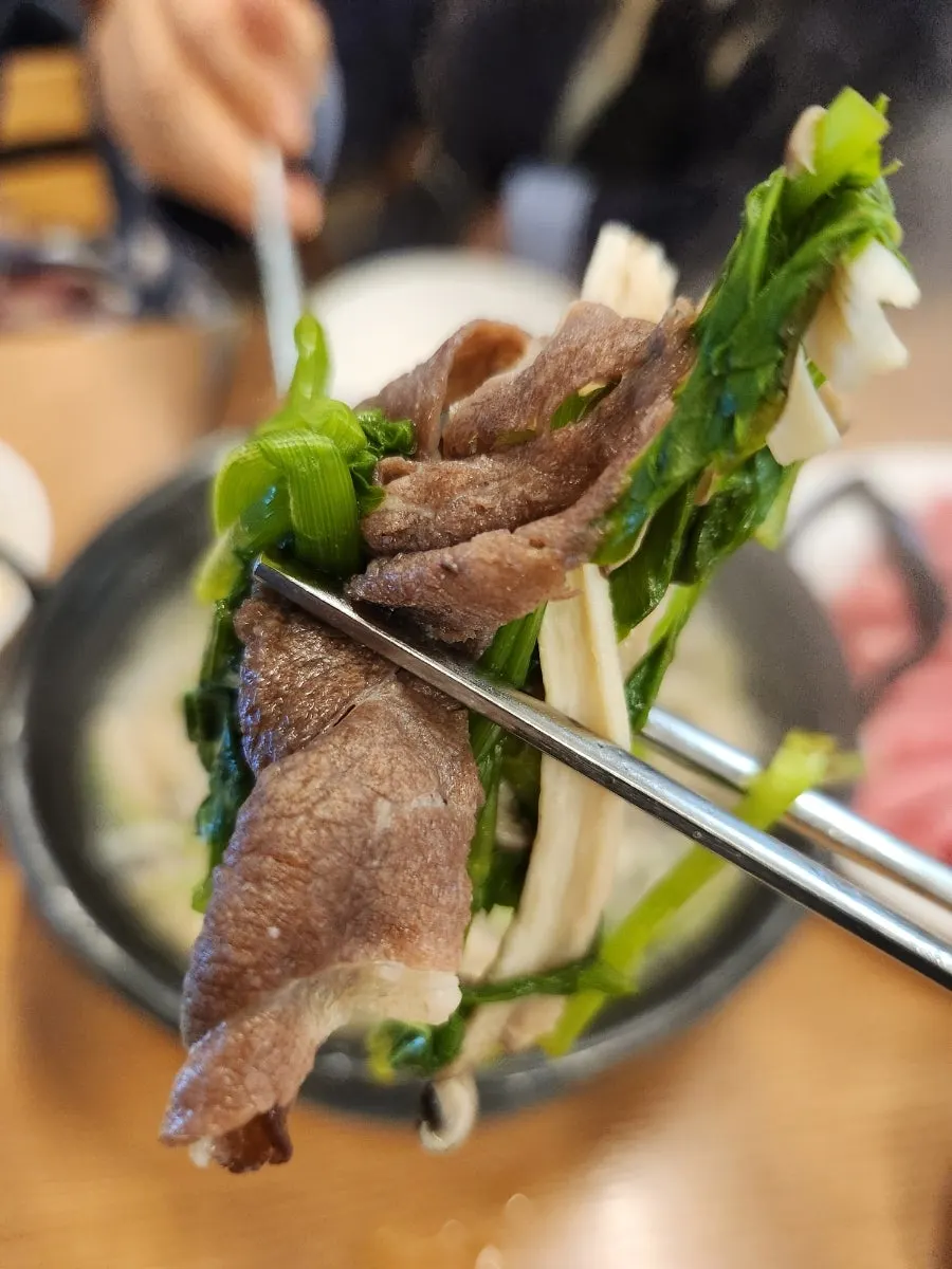 Beef cooking in the clear broth